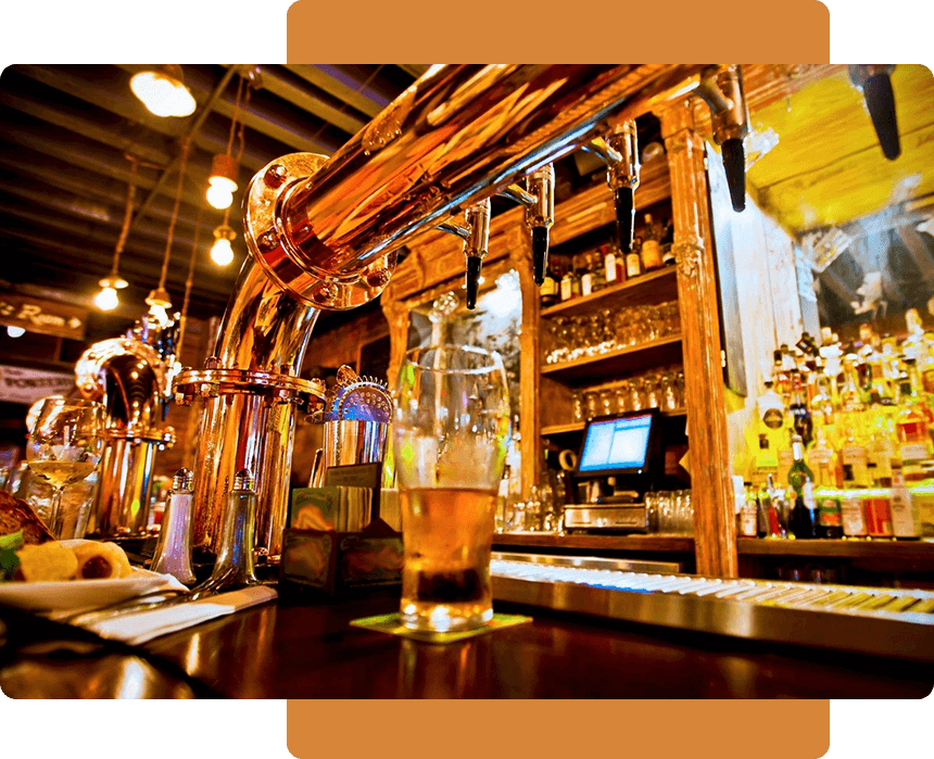 A glass of beer is on the bar.
