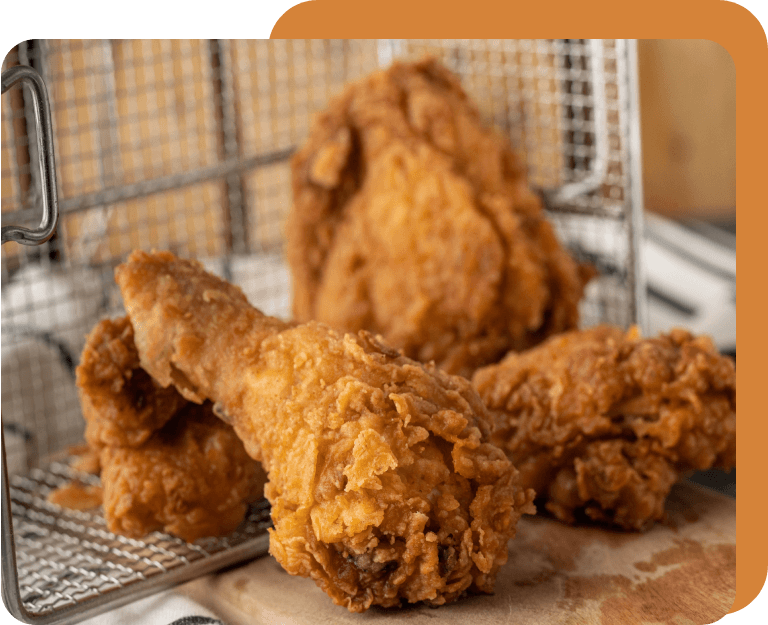 A basket of fried chicken sitting on top of a table.